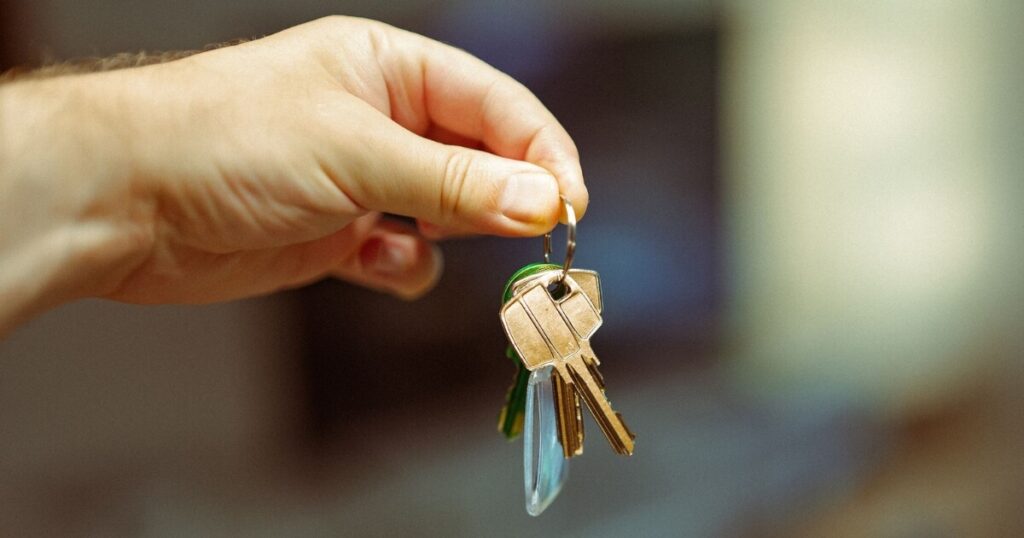 A hand holding a set of keys