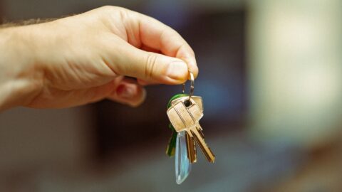 A hand holding a set of keys