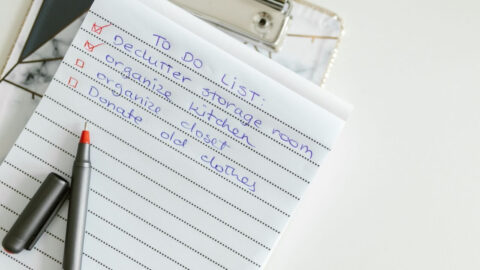 A neatly written to-do list on lined paper with a pen, perfect for organising tasks