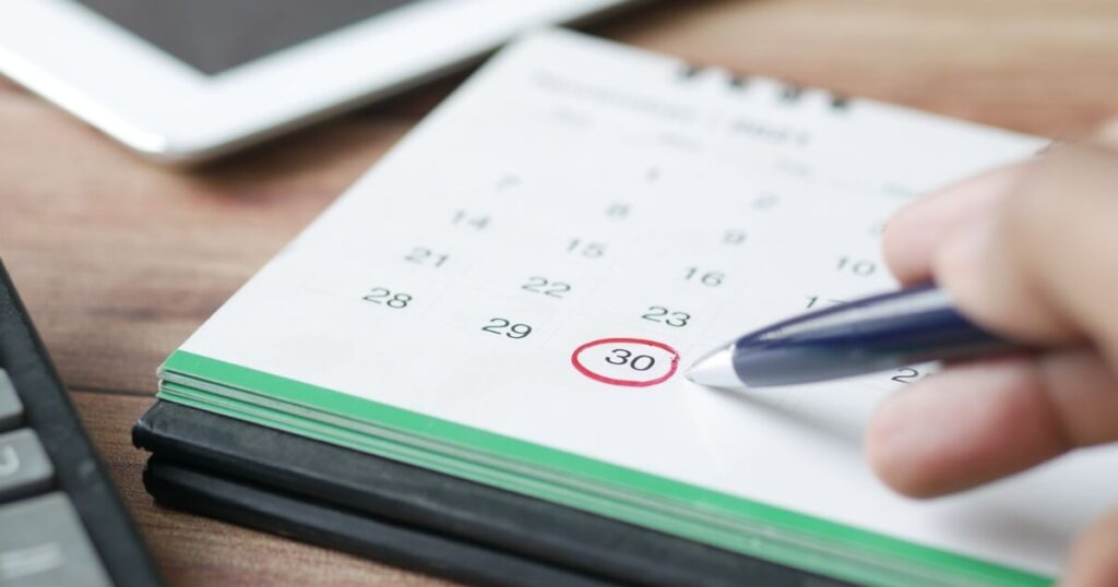 A white calendar with green border displaying the 30th date of the month circled in red with pen