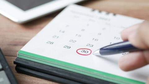 A white calendar with green border displaying the 30th date of the month circled in red with pen