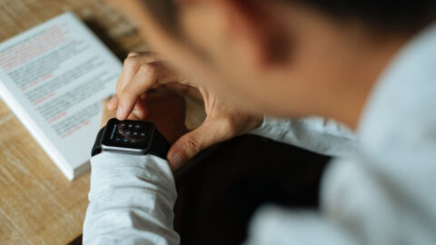 A man tapping on his smart watch