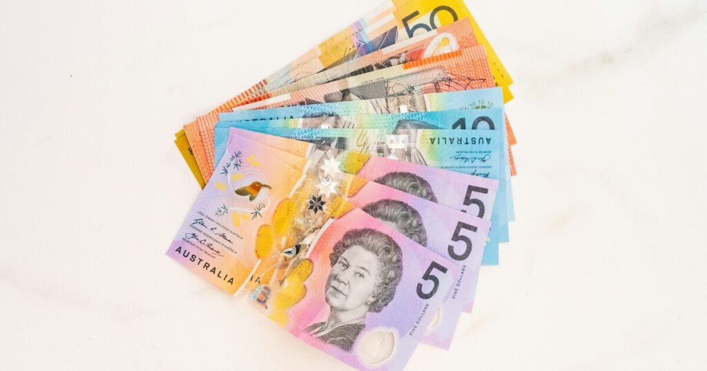 Australian dollar notes fanned out on a table, representing a rental bond refund