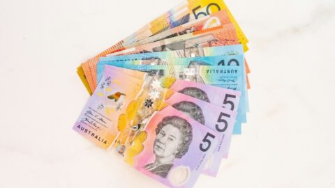 Australian dollar notes fanned out on a table, representing a rental bond refund