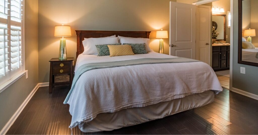 A cozy bedroom featuring a comfortable bed, modern decor, and warm lighting for a relaxing ambiance