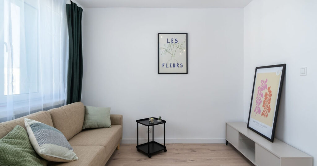 A stylish minimalist living room with artwork and cozy sofa