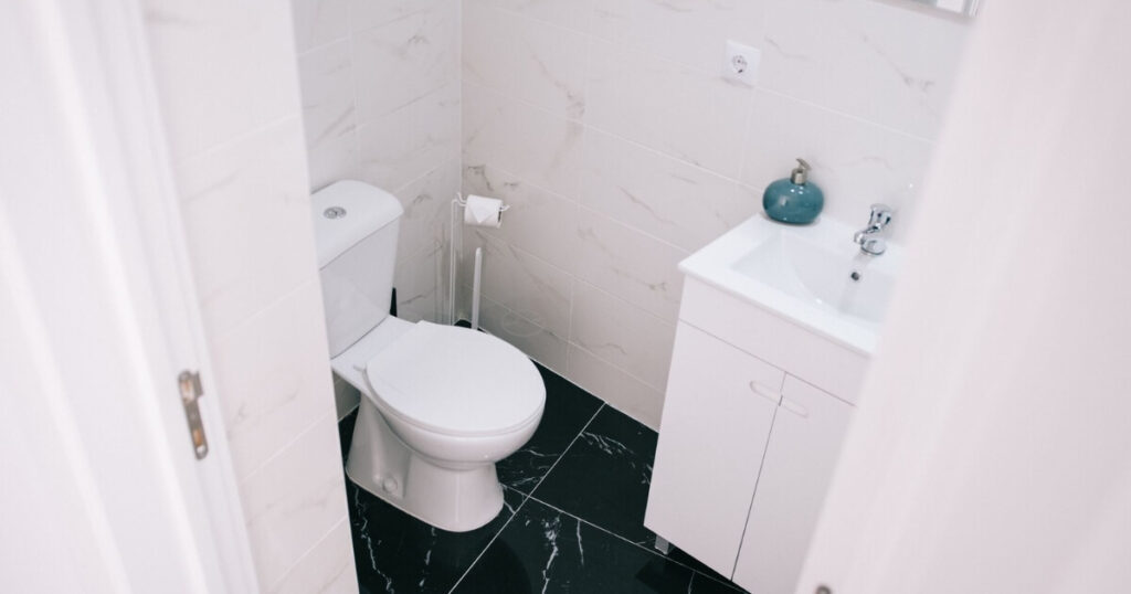 A contemporary bathroom showcasing a clean design with marble tiles and modern fixtures